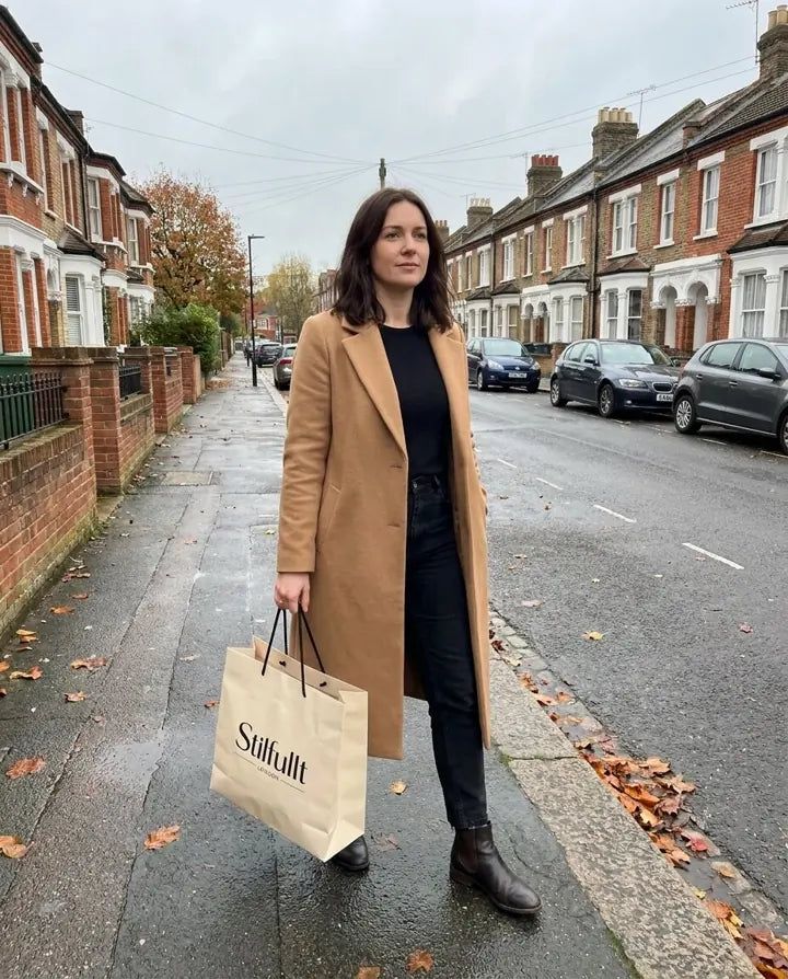Woman in camel coat carrying Stilfullt London bag on a London street